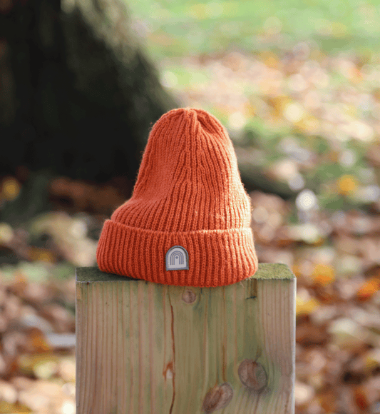 Orange knitted Hachure Quest Hat with logo on the front
