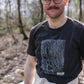 Man in the woods wearing Hachure brown t-shirt with white hachure print on the front