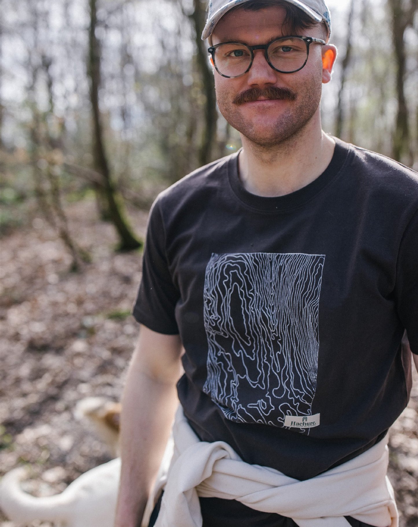 Man in the woods wearing Hachure brown t-shirt with white hachure print on the front