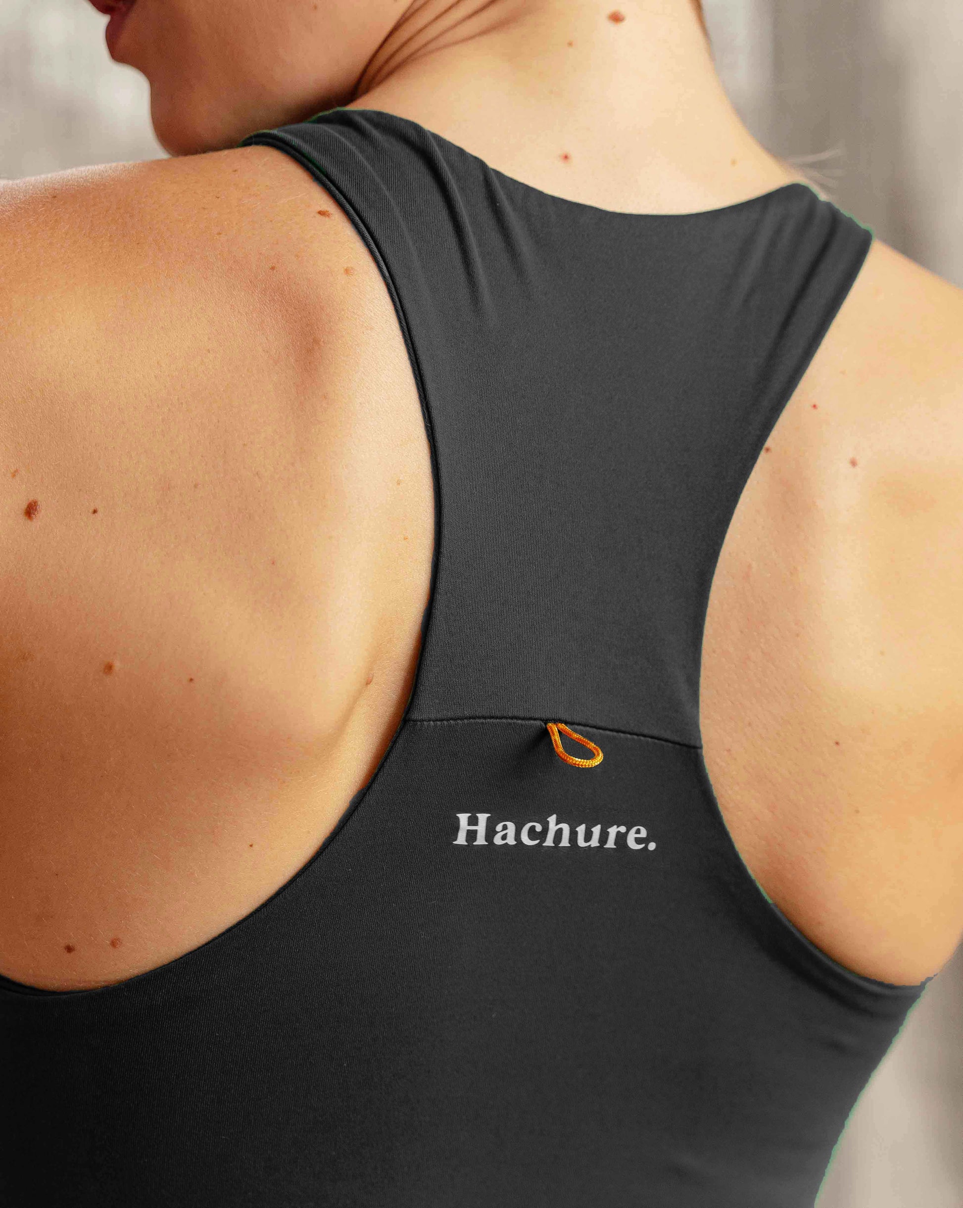 Woman wearing Hachure Fern Crop Top recycled polyester close up of branding on back