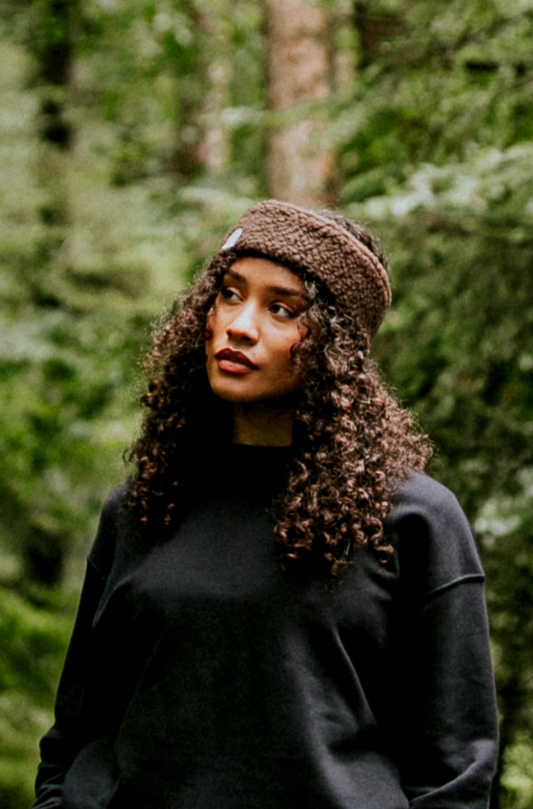 Woman wearing a fleece ear warmer in the forest