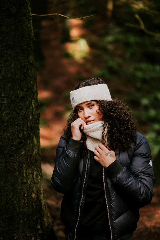 Woman wearing a fleece ear warmer and snood in forest