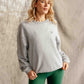 Woman in Hachure Pennine grey sweatshirt